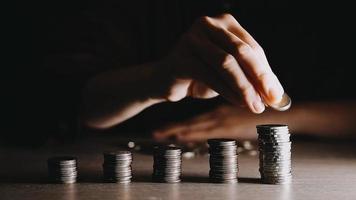 businessman holding coins putting in glass with using calculator to calculate concept saving money for finance accounting, Business, finance, investment, Financial planning. video