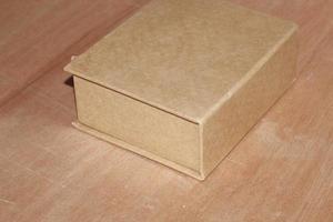 Brown paper box on wooden background mockup top view photo