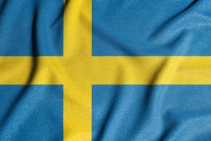 National flag of the Sweden. The main symbol of an independent country. Flag of Sweden. An attribute of the large size of a democratic state. photo