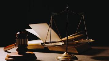 Justice and law concept.Male judge in a courtroom with the gavel, working with, computer and docking keyboard, eyeglasses, on table in morning light video