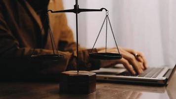 Business and lawyers discussing contract papers with brass scale on desk in office. Law, legal services, advice, justice and law video