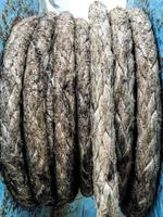 Old brown and gray frayed ship rope closeup. Classic texture. photo