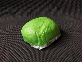 Green Bakpao.Asian steamed buns on wooden oval tray photo