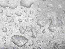water drops at metallic surface reflecting water and light. waterdrops. raindrops photo