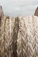 Old brown and gray frayed ship rope closeup. Classic texture. photo