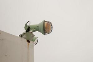 Marine signal light and emergency signal lamp off during the day, against the backdrop of the sea and sky photo