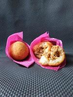 Indonesian Traditional Fritters Combro, made from deep fried cassava and filled with spice inside photo