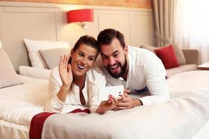 Happy couple resting in hotel room photo