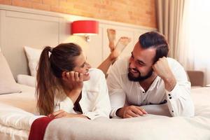 Happy couple resting in hotel room photo