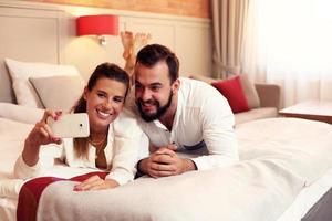 Happy couple resting in hotel room photo