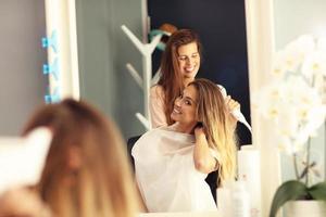 Happy woman in hair salon photo