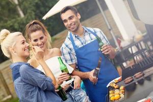 Group of friends having barbecue party photo