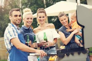 Group of friends having barbecue party photo