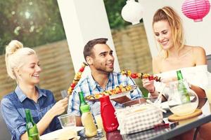 Group of friends having barbecue party photo