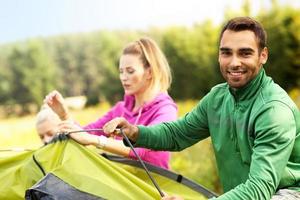 Group of friends putting up tent photo