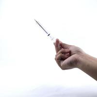 hand holding a small syringe isolated on a white background photo