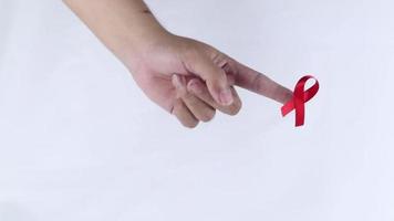 hand symbol with red ribbon signifying concern for people with HIV aids isolated on white background video