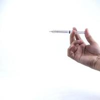 hand holding a small syringe isolated on a white background photo