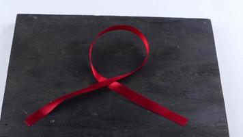 Red Support Ribbon isolated on white background. World aids day and national HIV AIDS and aging awareness month with red ribbon video