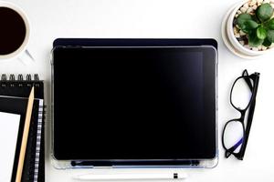 Top view modern white desk with tablet computer for graphic design, book pages and other accessories on  white background workspace concept, workspace style, online meetings, freelance work for copy photo