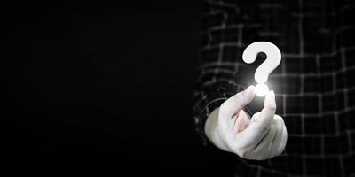 man holding question mark. concept of Question mark and FAQs, Ask question online, FAQ concept, what how and why, search information on internet. photo