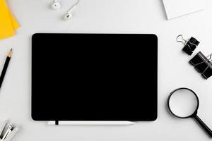 Top view modern white desk with tablet computer for graphic design, book pages and other accessories on  white background workspace concept, workspace style, online meetings, freelance work for copy photo