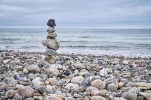 Stone pyramid on the beach overlooking the sea. Danish coast. Scandinavia landscape photo