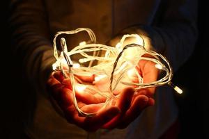 Woman holding fairy lights photo