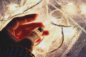 Woman holding fairy lights photo