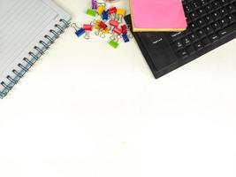 Flat lay, white desk in the office with layout space.with office equipment such as pencils, notebooks and keyboards at the top.mock up table photo