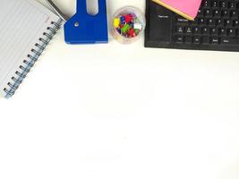 Flat lay, white desk in the office with layout space.with office equipment such as pencils, notebooks and keyboards at the top.mock up table photo