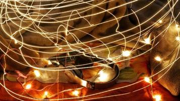 Headphones Surrounded By Fairy Lights In Long Exposure photo