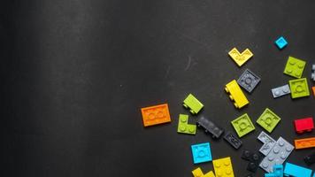 Plastic toy block on a black background photo