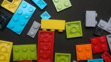 Plastic toy block on a black background photo