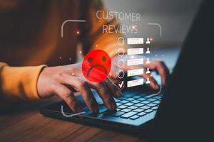 Unhappy man customer with sad emotion face on laptop. Bad review and service dislike poor quality, low rating, bad social media not good. Customer experience dissatisfied and testimonial concept. photo