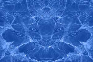 Defocus blurred transparent blue colored clear calm water surface texture with splashes and bubbles. Trendy abstract nature background. Water waves in sunlight with copy space. Blue watercolor shining photo