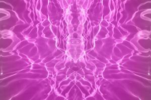 Defocus blurred transparent purple colored clear calm water surface texture with splashes and bubbles. Trendy abstract nature background. Water waves in sunlight with copy space. Pink water drop shine photo