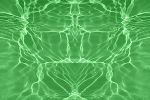 Defocus blurred transparent green colored clear calm water surface texture with splashes and bubbles. Trendy abstract nature background. Water waves in sunlight with copy space. Green water shining. photo
