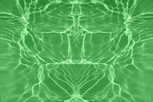 Defocus blurred transparent green colored clear calm water surface texture with splashes and bubbles. Trendy abstract nature background. Water waves in sunlight with copy space. Green water shining. photo