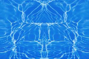Defocus blurred transparent blue colored clear calm water surface texture with splashes and bubbles. Trendy abstract nature background. Water waves in sunlight with copy space. Blue watercolor shining photo