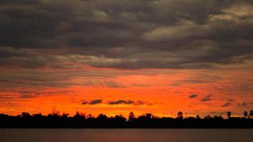 dramatic orange sky with black clouds  At dusk, the weather is inclement.  cover design template for book, magazine, website photo