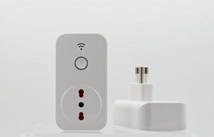 Smart wi-fi plug with energy monitor isolated on white background. photo