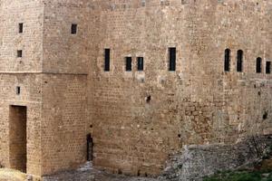 Stone wall of an ancient fortress on the seashore in Israel. photo