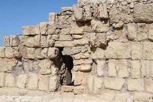 Stone wall of an ancient fortress on the seashore in Israel. photo