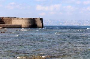 Stone wall of an ancient fortress on the seashore in Israel. photo