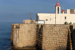 Stone wall of an ancient fortress on the seashore in Israel. photo