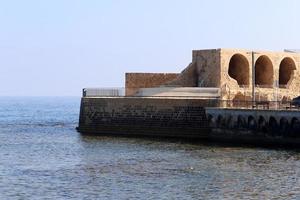 Stone wall of an ancient fortress on the seashore in Israel. photo