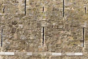 Stone wall of an ancient fortress on the seashore in Israel. photo