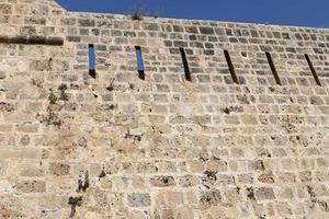 Stone wall of an ancient fortress on the seashore in Israel. photo