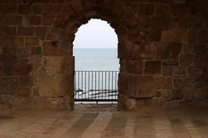 Stone wall of an ancient fortress on the seashore in Israel. photo